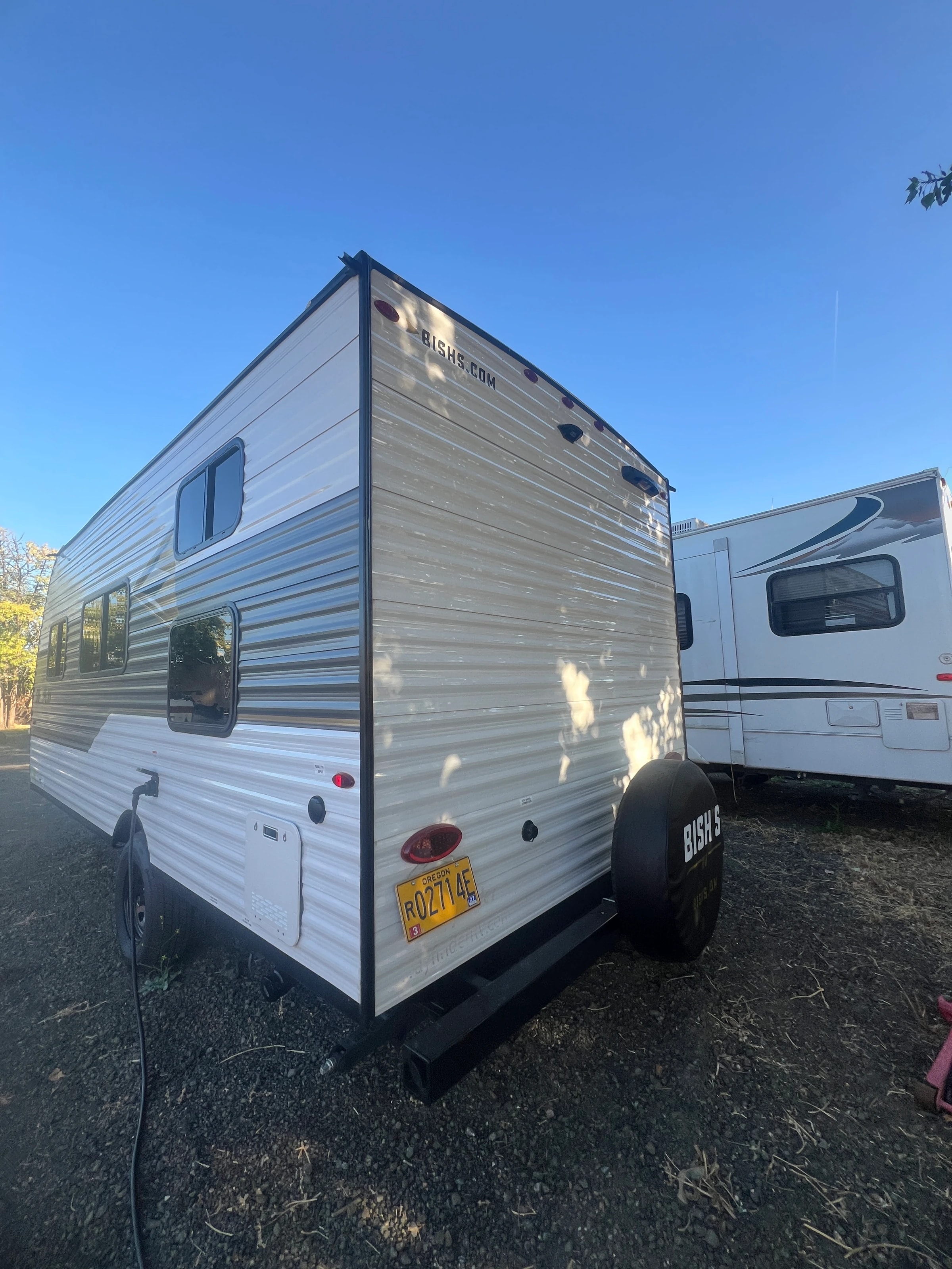 Rear three-quarter view of the trailer parked between others