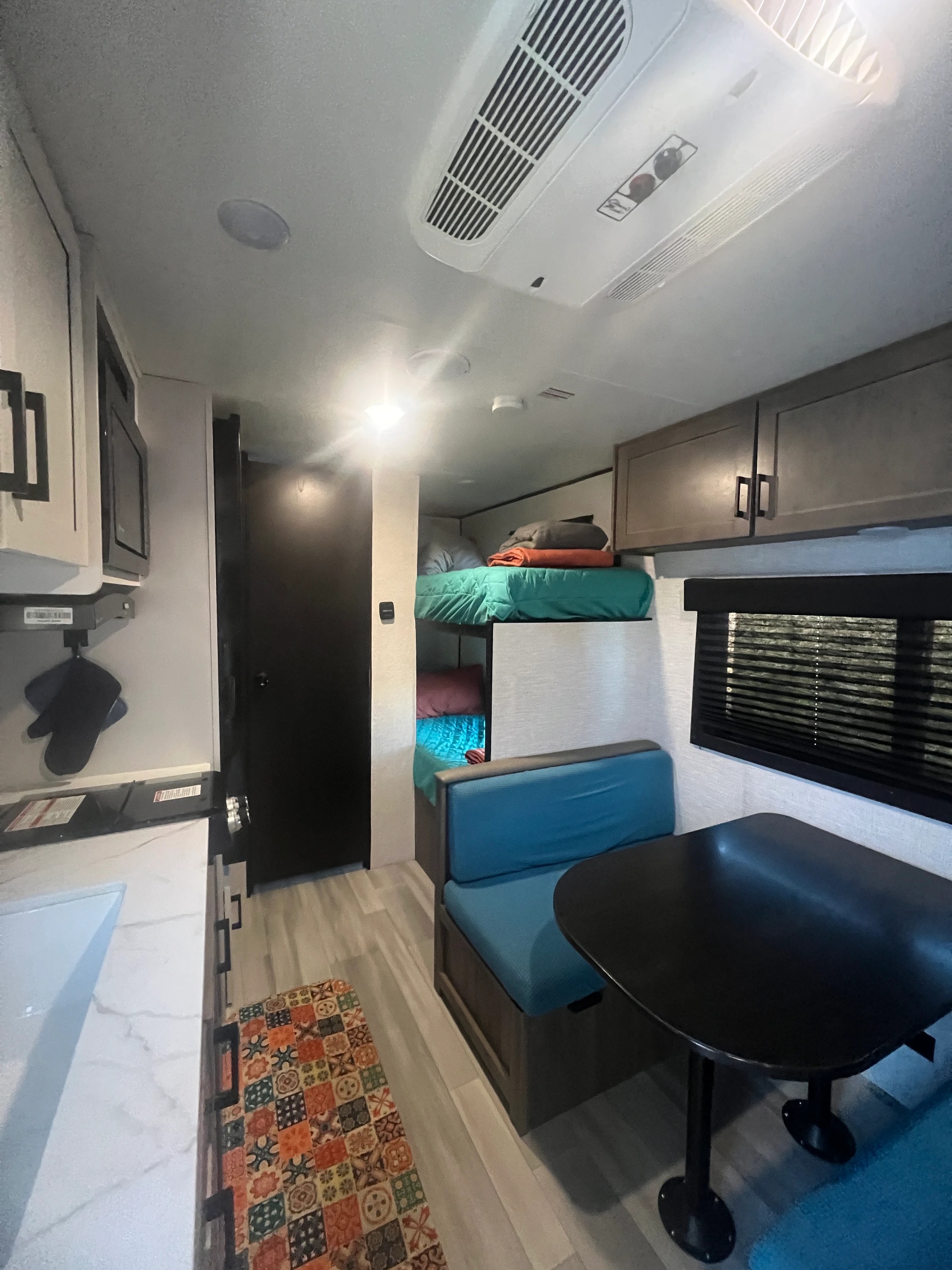 Down the trailer from the front bed, past the dinette to the bunks