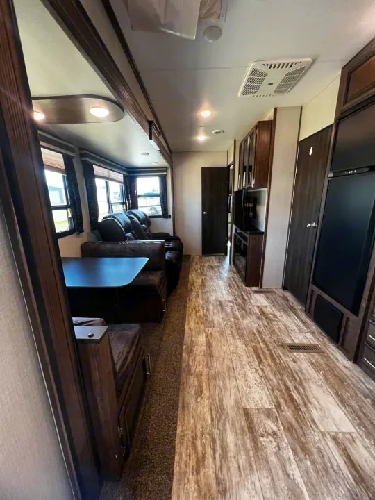 Interior view of the dinette and hallway leading toward the kitchen and bedroom