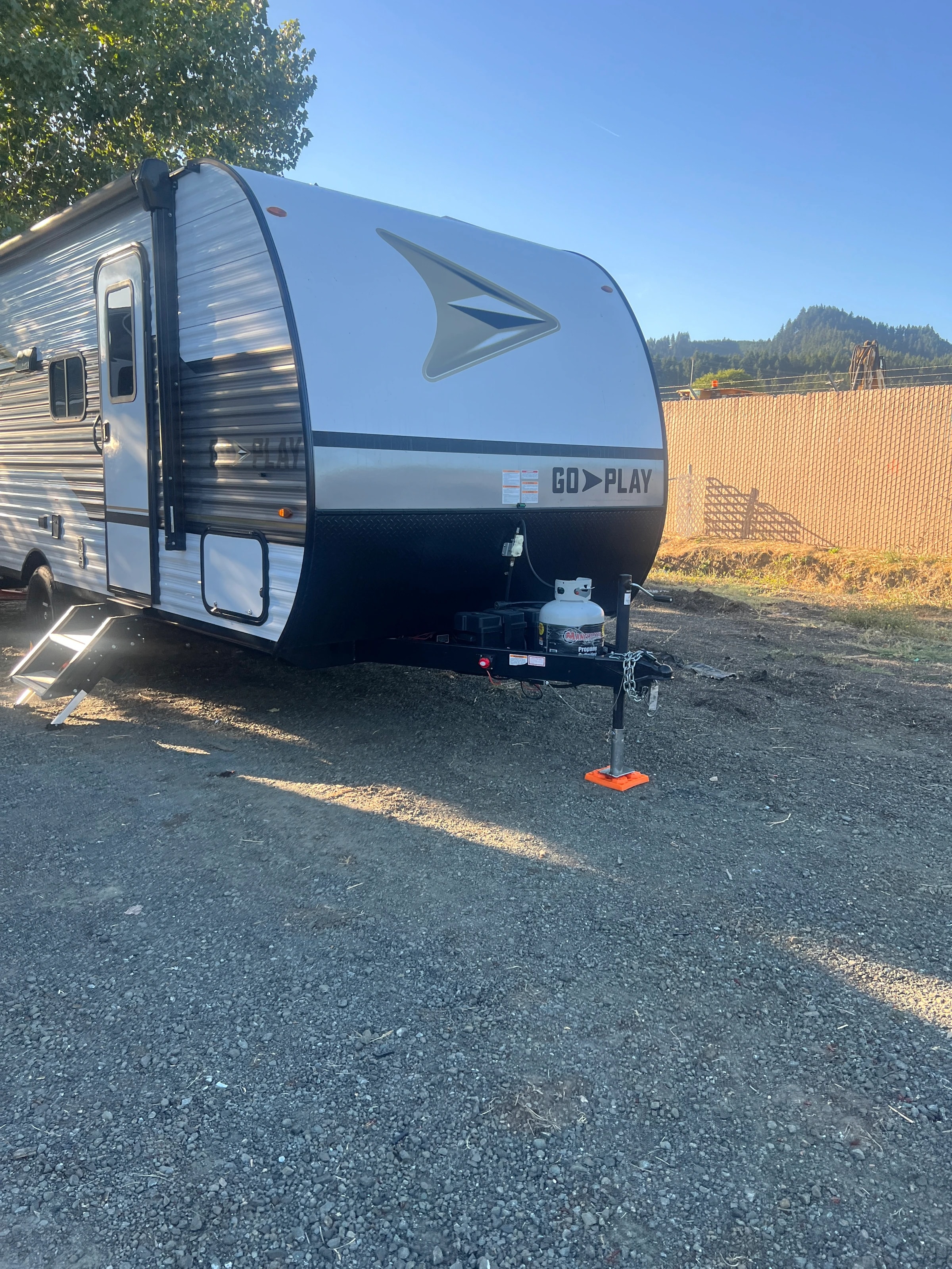 Front three-quarter view of the trailer with the hills behind