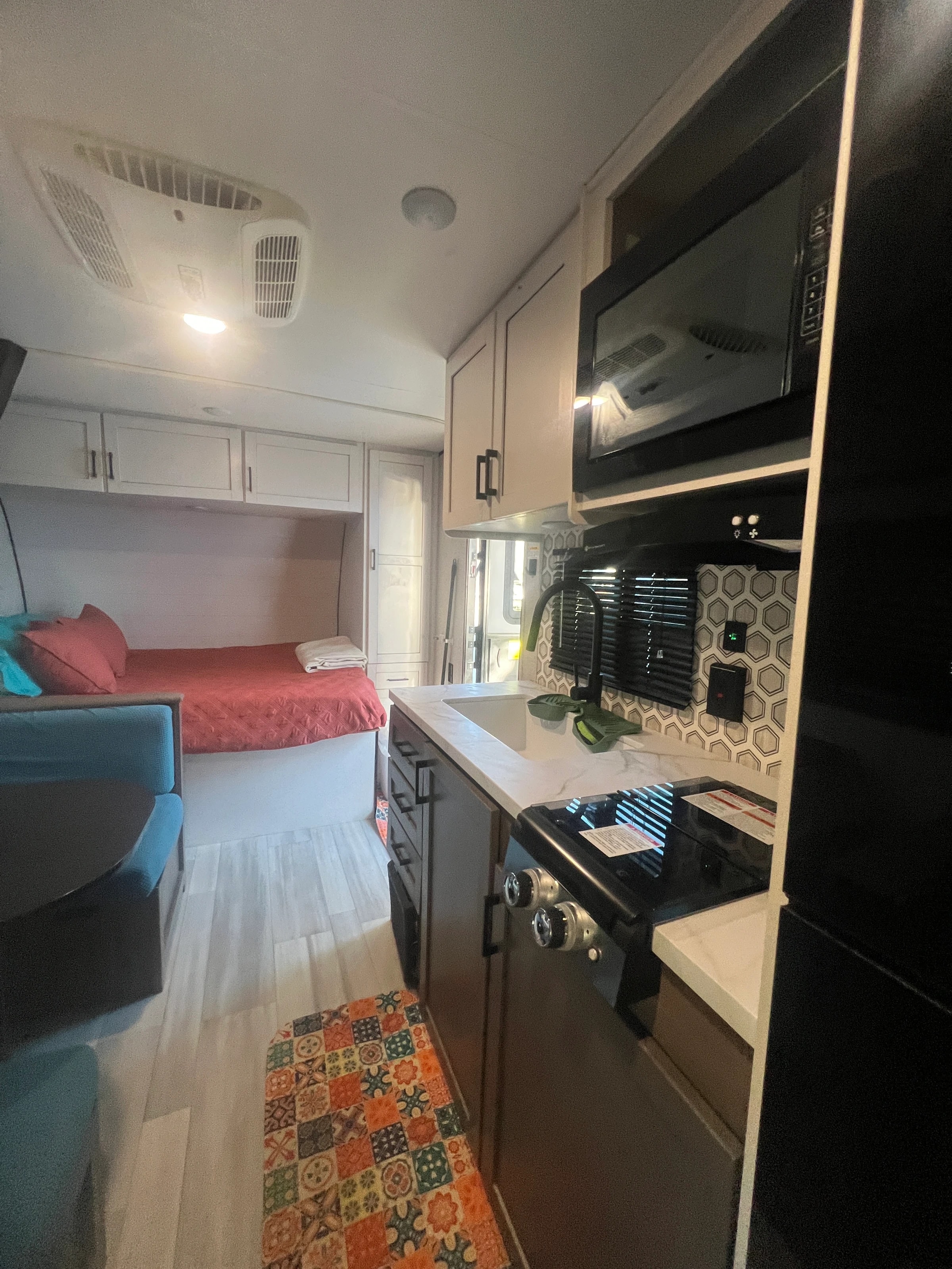 Galley with two-burner cooktop and microwave, the front bed beyond