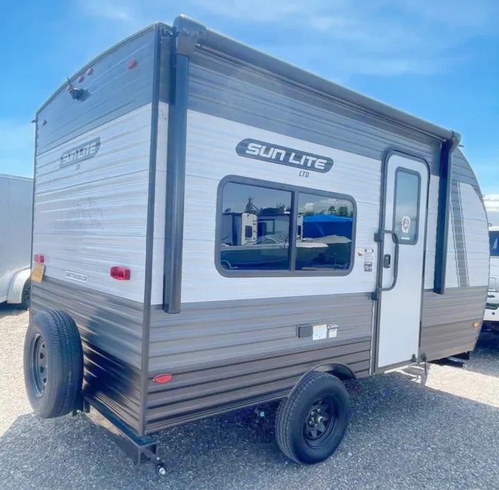 Rear three-quarter view showing the side entry door and awning arm