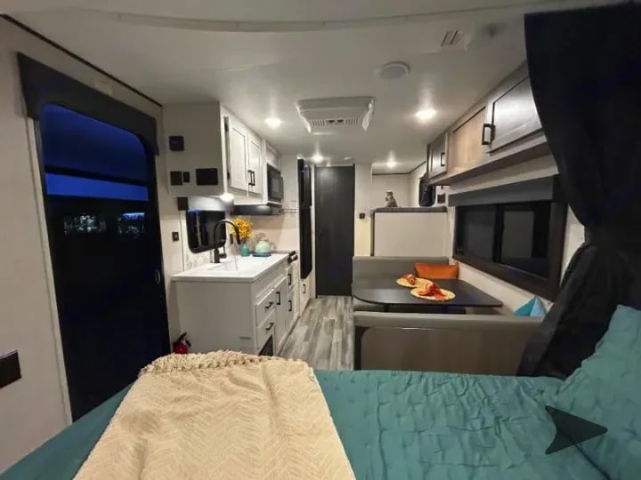 View from the bed back through the kitchen and dinette toward the entry door