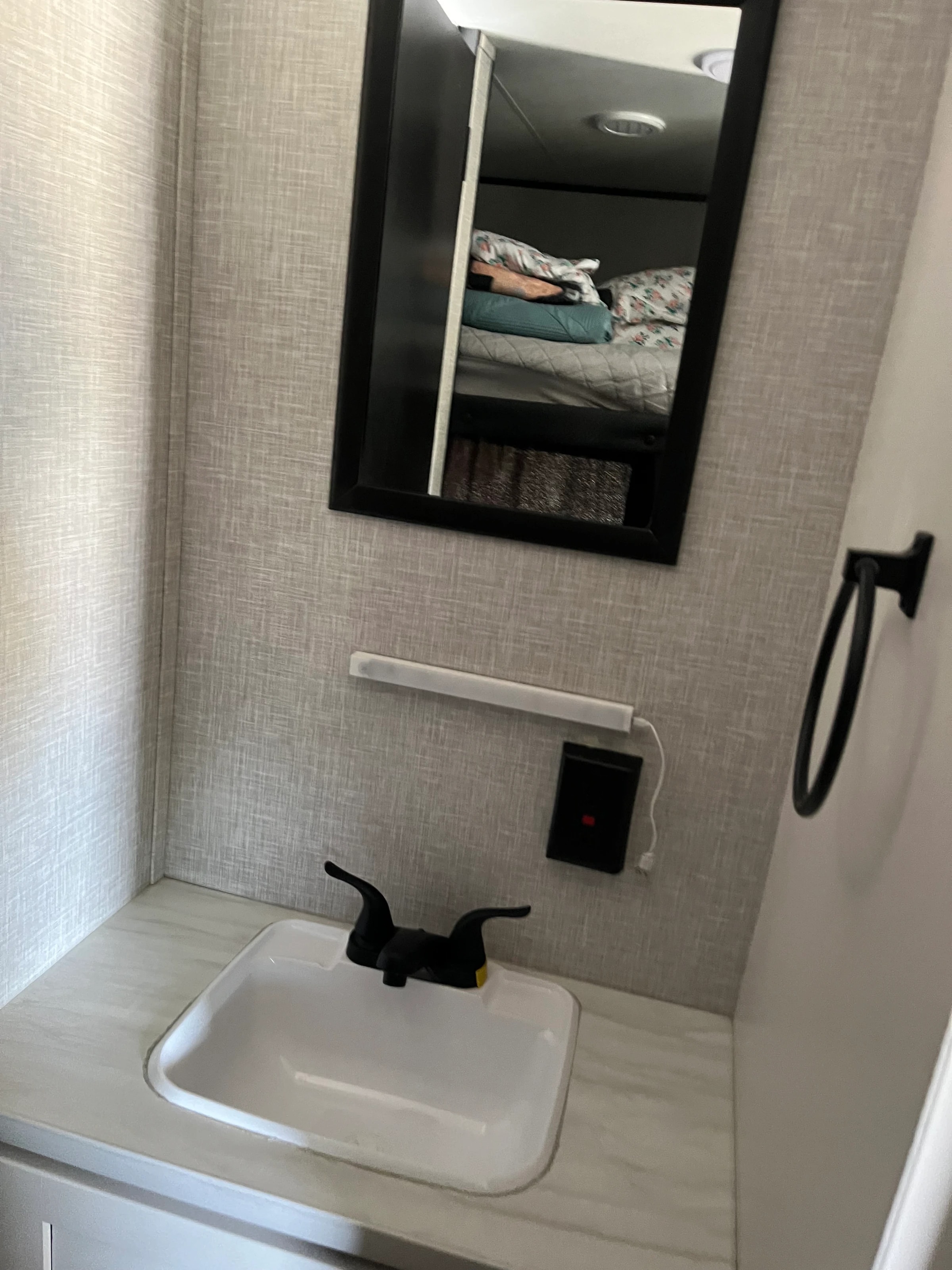 Bathroom sink faucet and mirror with shower fixture overhead