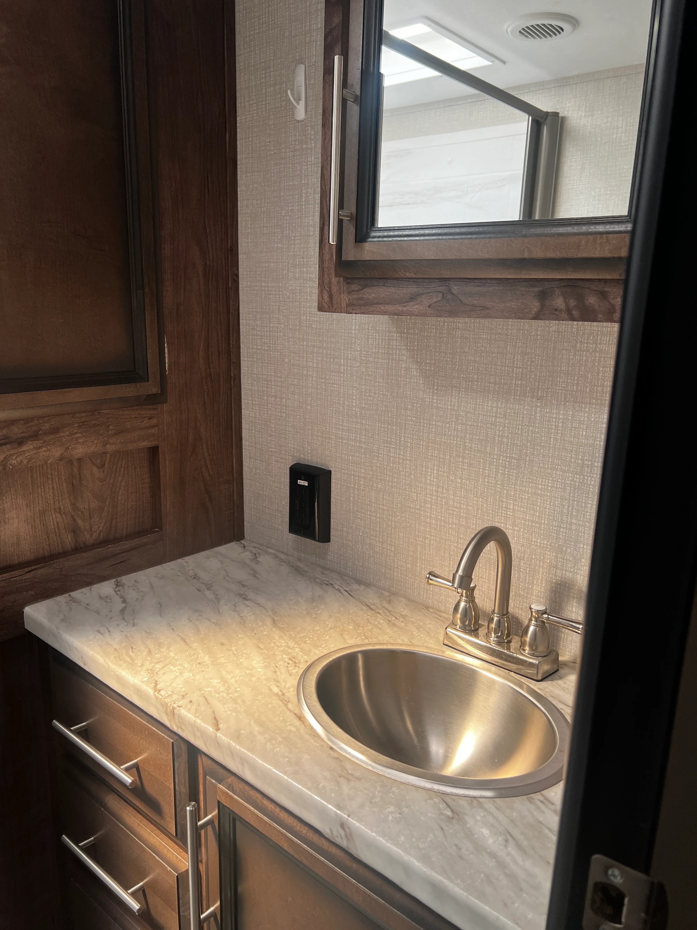 Close-up of the bathroom vanity faucet and stone countertop