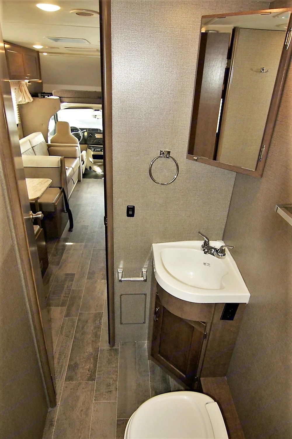 Bathroom vanity sink with mirrored cabinet, seen from the hallway