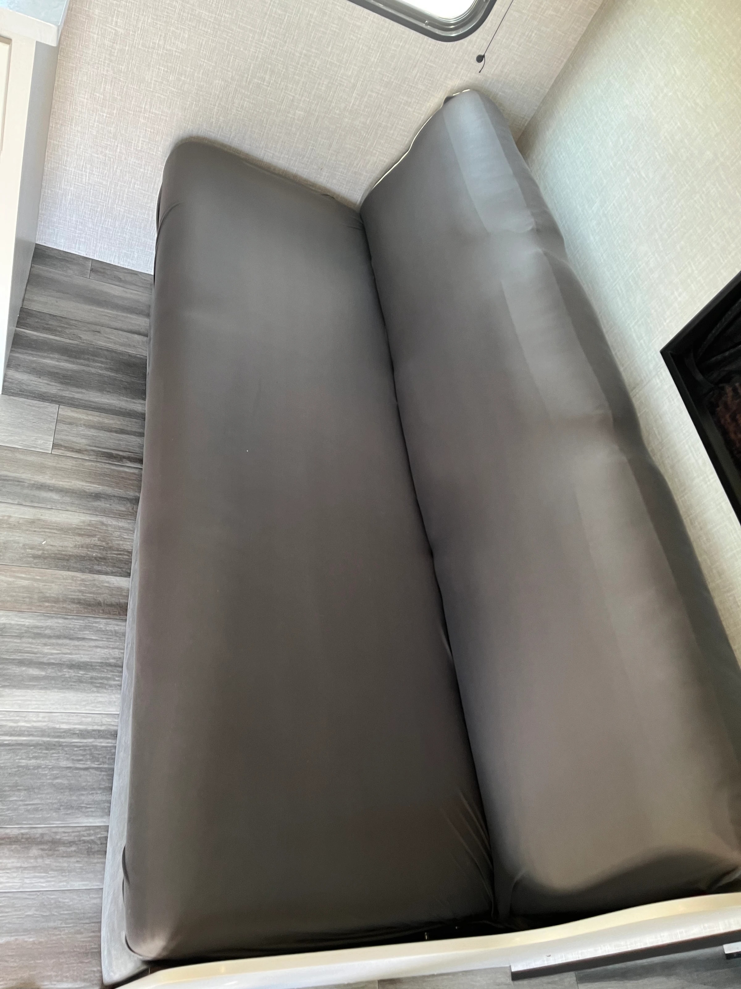 Close view of the gray jackknife sofa upholstery