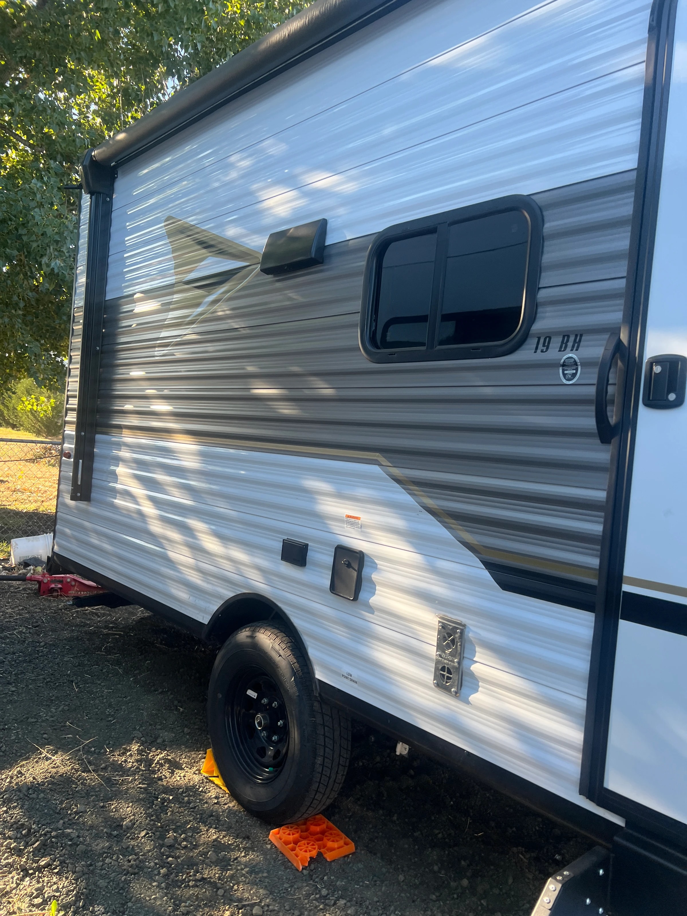 Door side close up — entry step, wheel and storage hatch