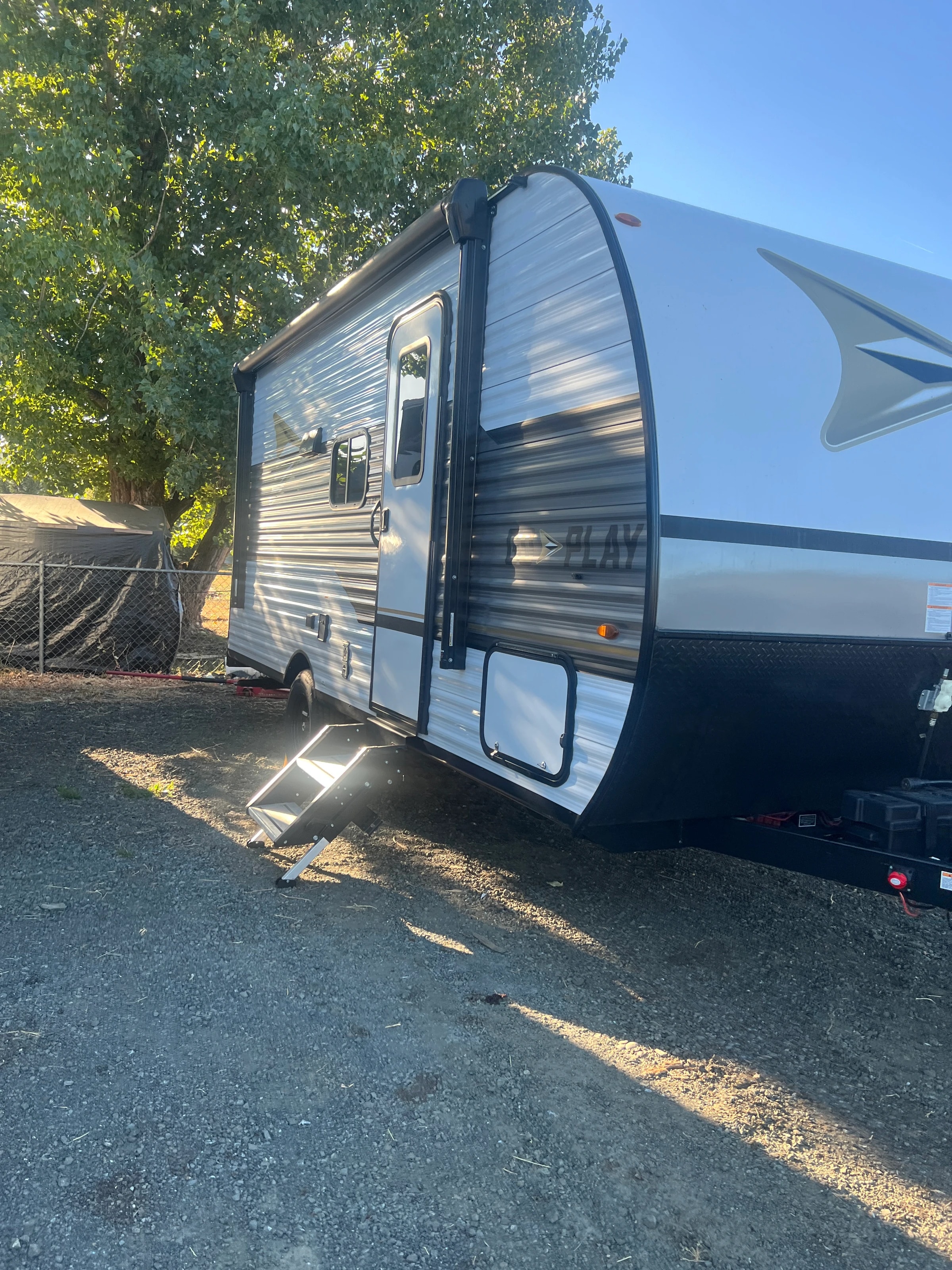 Door side of the trailer under afternoon shade